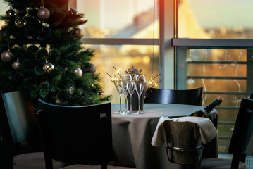 Table in restaurant with a miracle candles and champagne glasses . During late evening, high iso image.