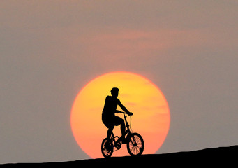 Silhouette  Cycling  on blurry sunrise  sky   background.