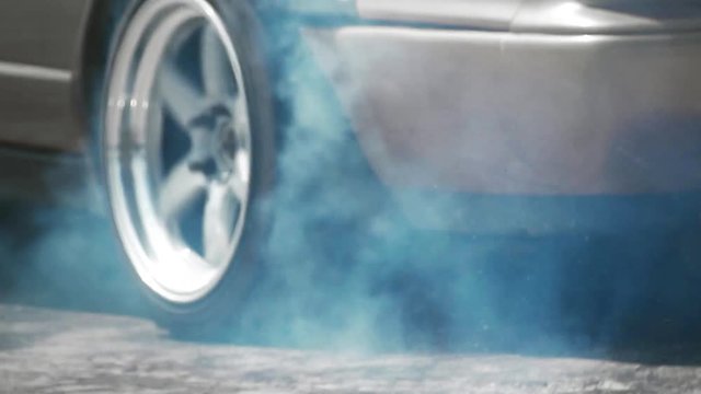slow motion race drift car burning tires on speed track