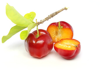 Fresh acerola fruit and slice isolated on white