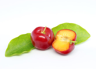 Fresh acerola fruit and slice isolated on white