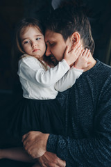 Dad holds the baby in his arms. The concept of educating the father of young children, Happy childhood, a friendly family.