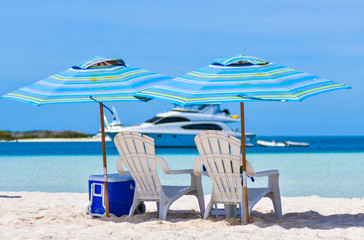 White Chairs and Umbrella beach canopy with Sea View at tropical blue water beach