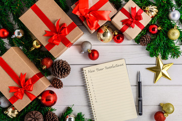 New Year's Resolutions List written on Notebook with Christmas fir tree and decoration
