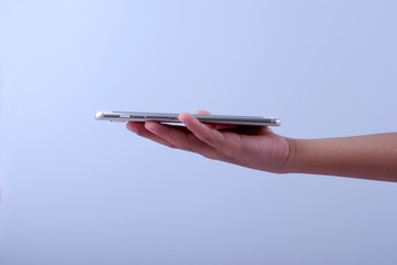 Man holding a white mobile phone with white screen isolated on white background