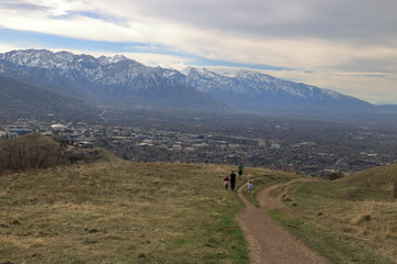 Fototapeta na wymiar Family on a stroll in the foothills of the Wasatch enjoying views of downtown Salt Lake City