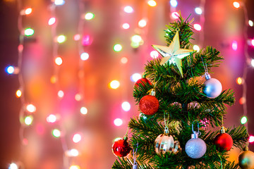 Christmas decoration star and balls Hanging on pine branches christmas tree