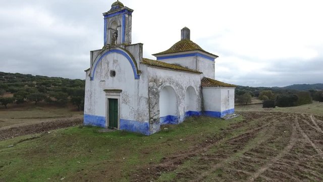 Small old chapel in the middle of cork oaks forest field aerial shot 4k