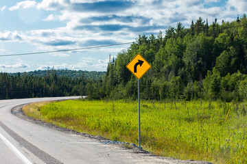 Slight bend or curve in the road ahead, Warning for a curve to the right, Warning Road Sign on the...
