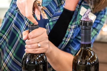 Bartender opening a bottle of wine at a wine tasting Place