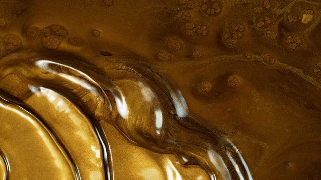 Super Slow Motion Shot of Gold Metallic Background at 1000fps.