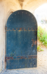 old opened metal door in a medieval castle close up