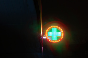 sign first aid cross sign pharmacy during rain bright hope © evgris