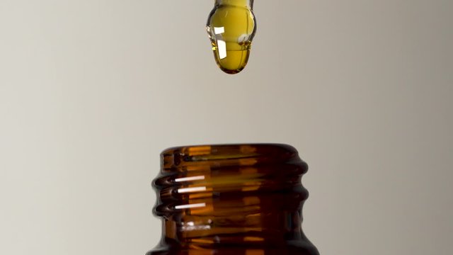 Gold oil in retro rustic brown glass bottle dripping medication tincture homeopathy