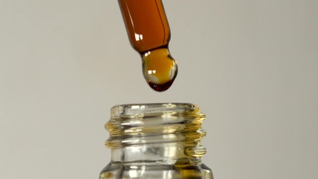 Classic golden oil dropper cannabis cbd thc marijuana medication isolated