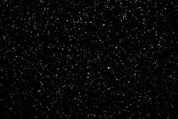 Chaotic white star bokeh on a isolated black background. falling blurry bokeh snow overlay, starry sky. white spots on black background, white drops and spots. abstraction.