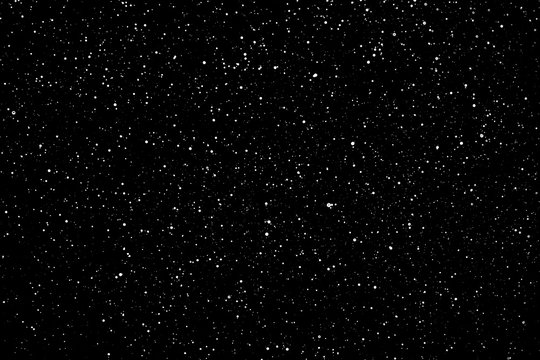 Chaotic white star bokeh on a isolated black background. falling blurry bokeh snow overlay, starry sky. white spots on black background, white drops and spots. abstraction.