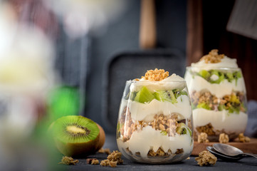 Kiwi parfait dessert in glass on dark background