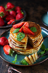 Classic American Breakfast pancake with honey and berries. Still life of lush pancakes, honey and strawberries.