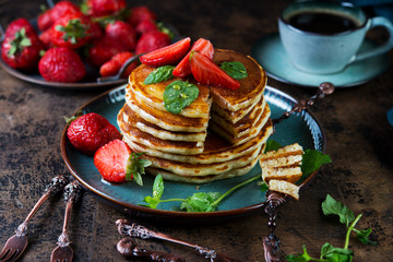 Classic American Breakfast pancake with honey and berries. Still life of lush pancakes, honey and strawberries.