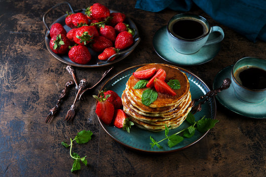 Classic American Breakfast pancake with honey and berries. Still life of lush pancakes, honey and strawberries.