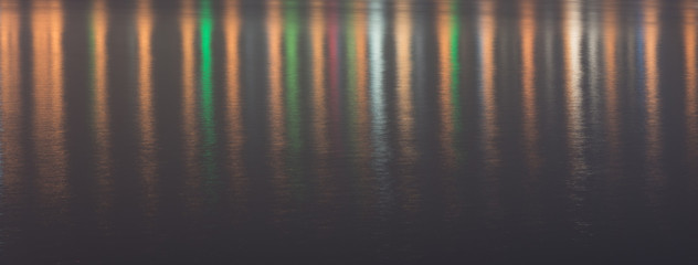 Colored light reflections on the water