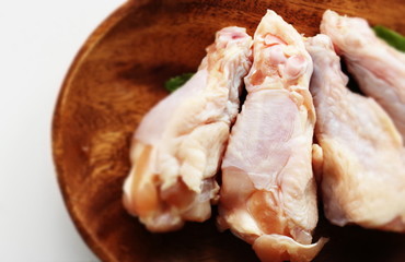 Chicken drumsticks on wooden plate with copy space