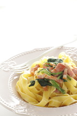 Italian food, spinach and bacon fettuccine flat pasta on plate