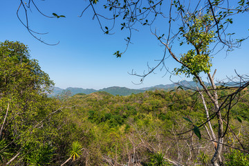 beautiful blue sky high peak mountains mist fog wildlife green forest at Phu Khao Hin Pakarang,  Khao Koh, Phetchabun, Thailand. guiding idea long weekend for backpacker camping hiking  