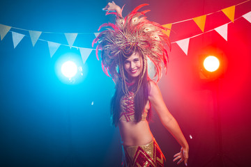 Carnival, dancer and holiday concept - Beauty brunette woman in cabaret suit and headdress with natural feathers and rhinestones.