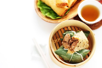 Chinese dumpling, meat and sticky rice wrapped zongzi in bamboo basket