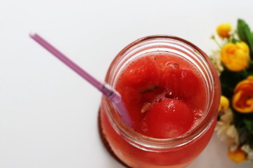 Tropical drink, watermelon and soda in jar on white background 