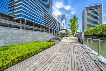 Empty wooden footpath front modern building.