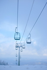 Funicular for tourists, skiers and snowboarders. lift to transport people in the mountains. the cable car on the background of blue mountains. funicular in the mountains