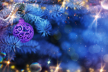Obraz na płótnie Canvas Christmas and New Year holidays background. Glitter lights backdrop. Winter season. Text space. Closeup of Christmas-tree.
