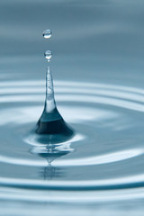 Beautiful splash of water drop on water surface, macro photo