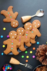 Christmas food. Gingerbread man cookies in Christmas concept settings background. Xmas dessert. background elements. Copy space © Manaswi