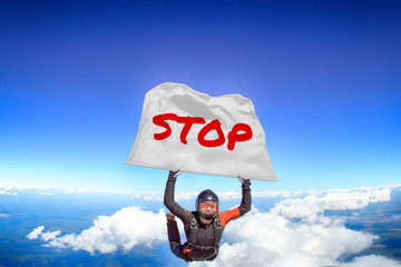 Stop. Flag in skydiving. People in free fall.Teampleat skydiver. Extreme sport.