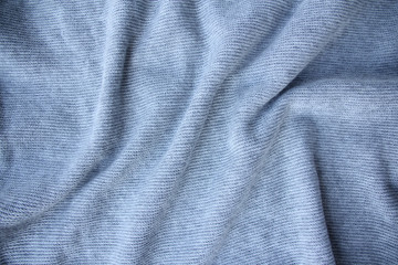 sample of a thin knitted woolen fabric with soft folds, the concept of fashion and style, needlework, copy space