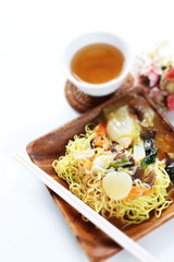 Fototapeta na wymiar Chinese food, stir fried vegetarian and scallop on pan fried ramen noodles 