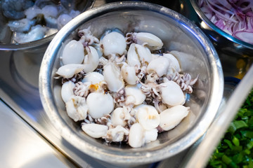 Boiled fresh squids in container of kitchen ingredient for cooking food.