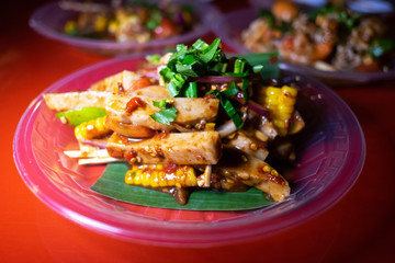 Spicy salad pressed pork with corn and fermented fish sauce. Thai popular delicious local street food.