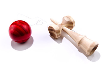 Kendama japanese wooden toy on isolated on white. Wood toy with red bal.