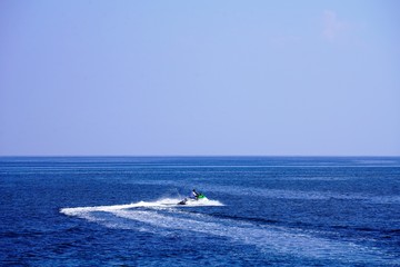 Fototapeta premium speeding jet ski in the deep blue azure sea