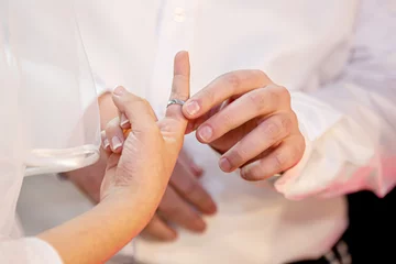 Fotobehang Jewish wedding. Jewish groom puts a ring on the finger of a Jewish bride. © Elisha