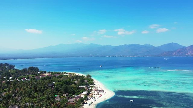 Bali, Indonesia, breathtaking panorama with small tropical island, beautiful clear ocean with corals and mountains in the background