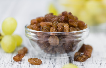 Portion of fresh Raisins on an old wooden table