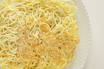 Chinese food, pan fried ramen noodles on white dish