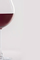 Glass of red wine on a white background and with soft shadow. There is a place for text.