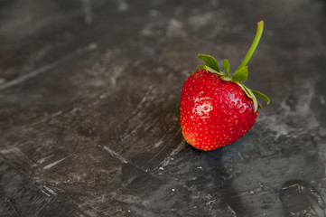 Fresh strawberries closeup. Ripe strawberries on a dark background and copy space.